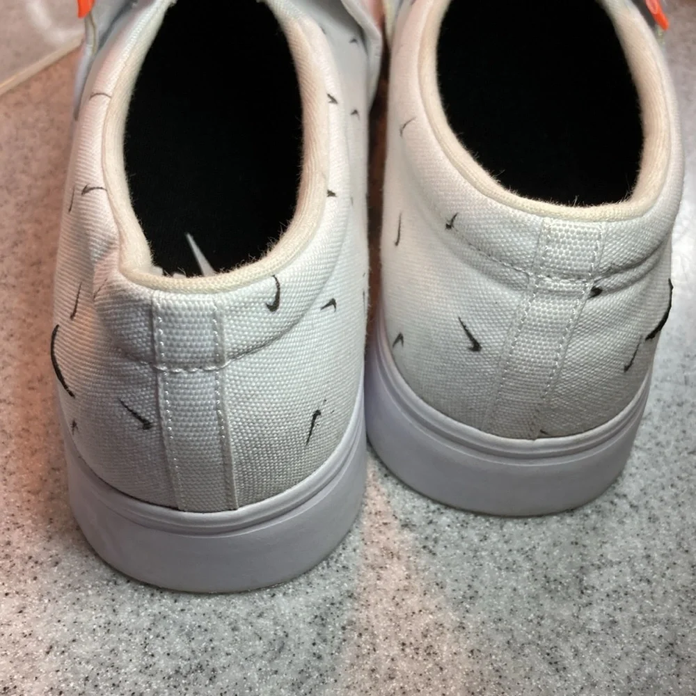 Size 9.5 Nike white slip on surfer skater‎ style with swooshes all over. 5